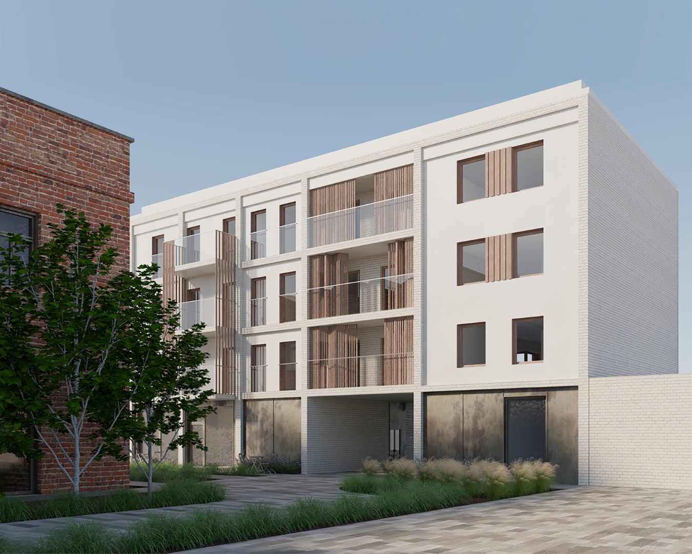 nowoczesny budynek mieszkalny o minimalistycznej bryle. Fasada wykonana jest z jasnych materiałów z drewnianymi detalami i balkonami. Otoczenie tworzy zieleń i brukowane ścieżki, co podkreśla estetykę przestrzeni miejskiej.